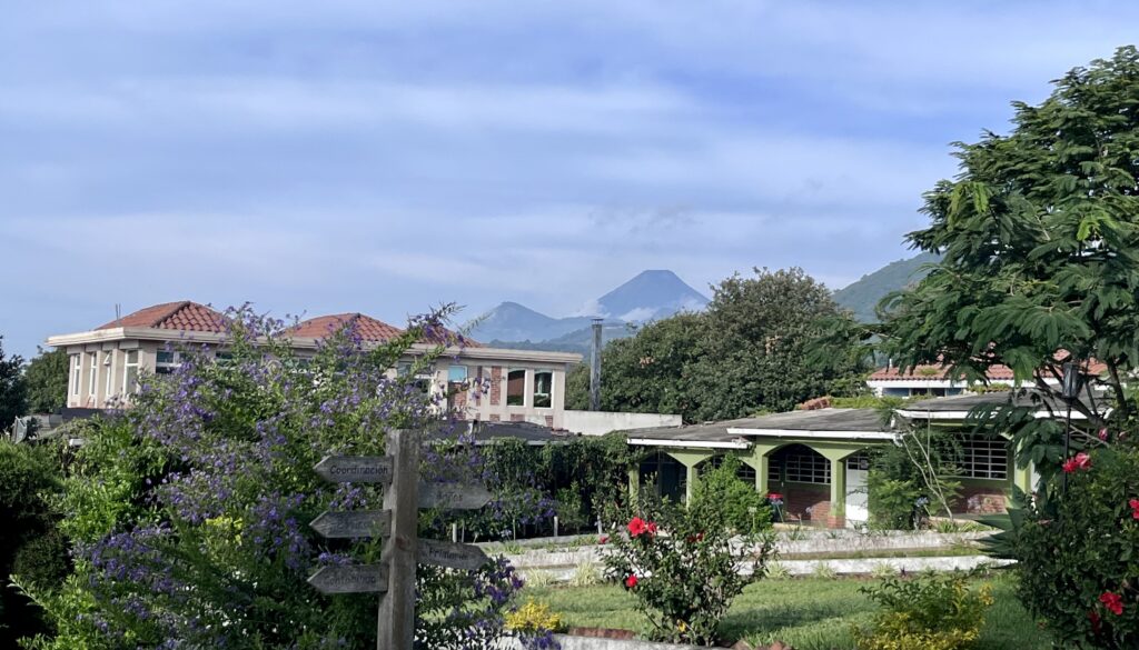 The IMA School campus in Guatemala with a volcano rising behind the classrooms